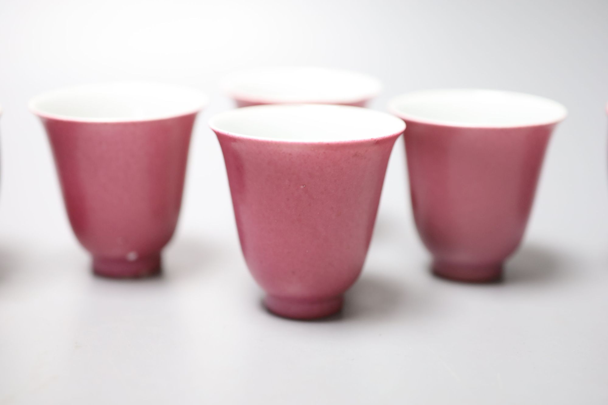 Four Chinese ruby ground cups, and a similar pair of cups, height 6cm